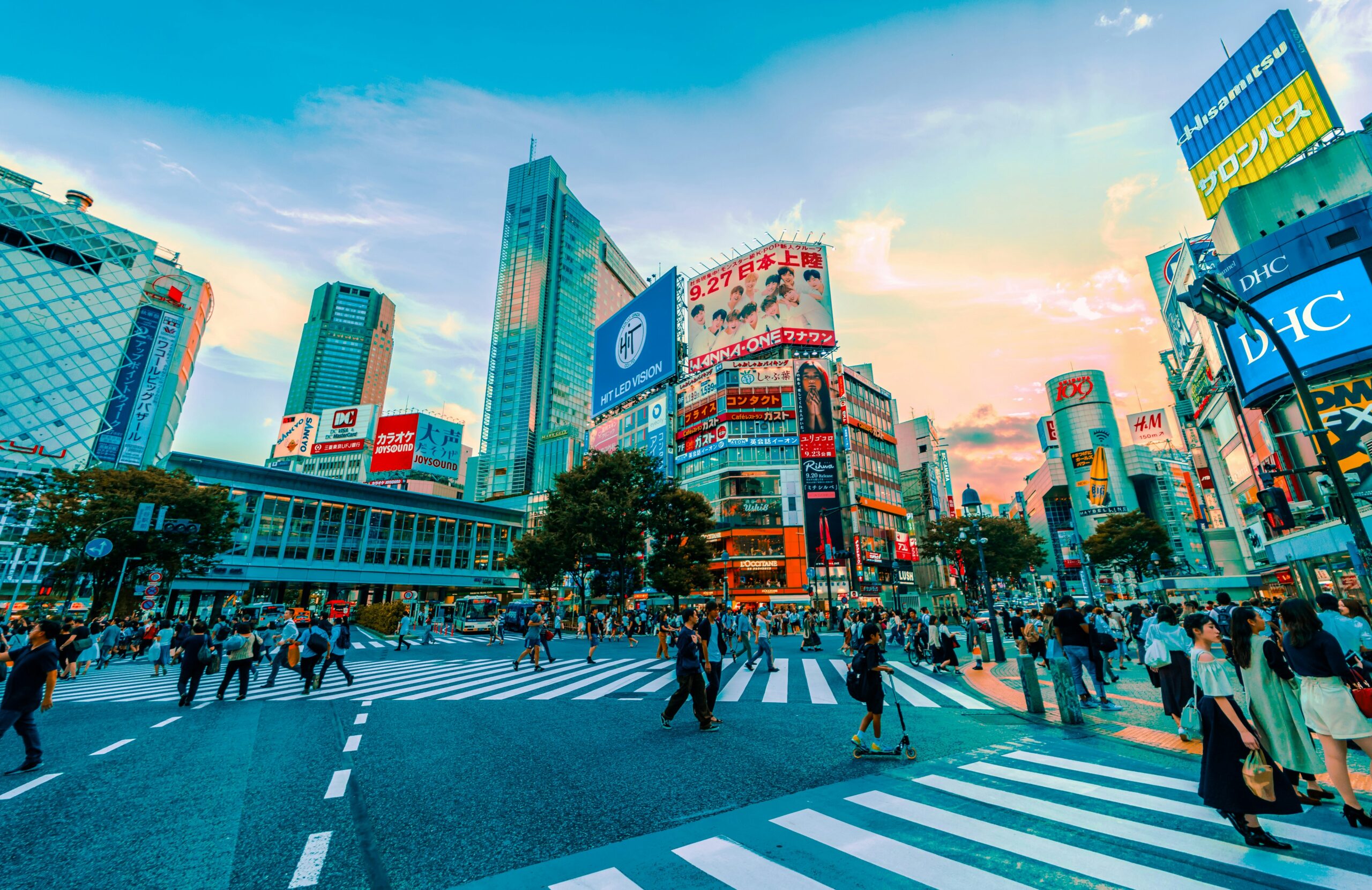 Busy Shibuya Crossing in Tokyo with colorful billboards and crowds, representing Japan's competitive and high-impact digital advertising landscape