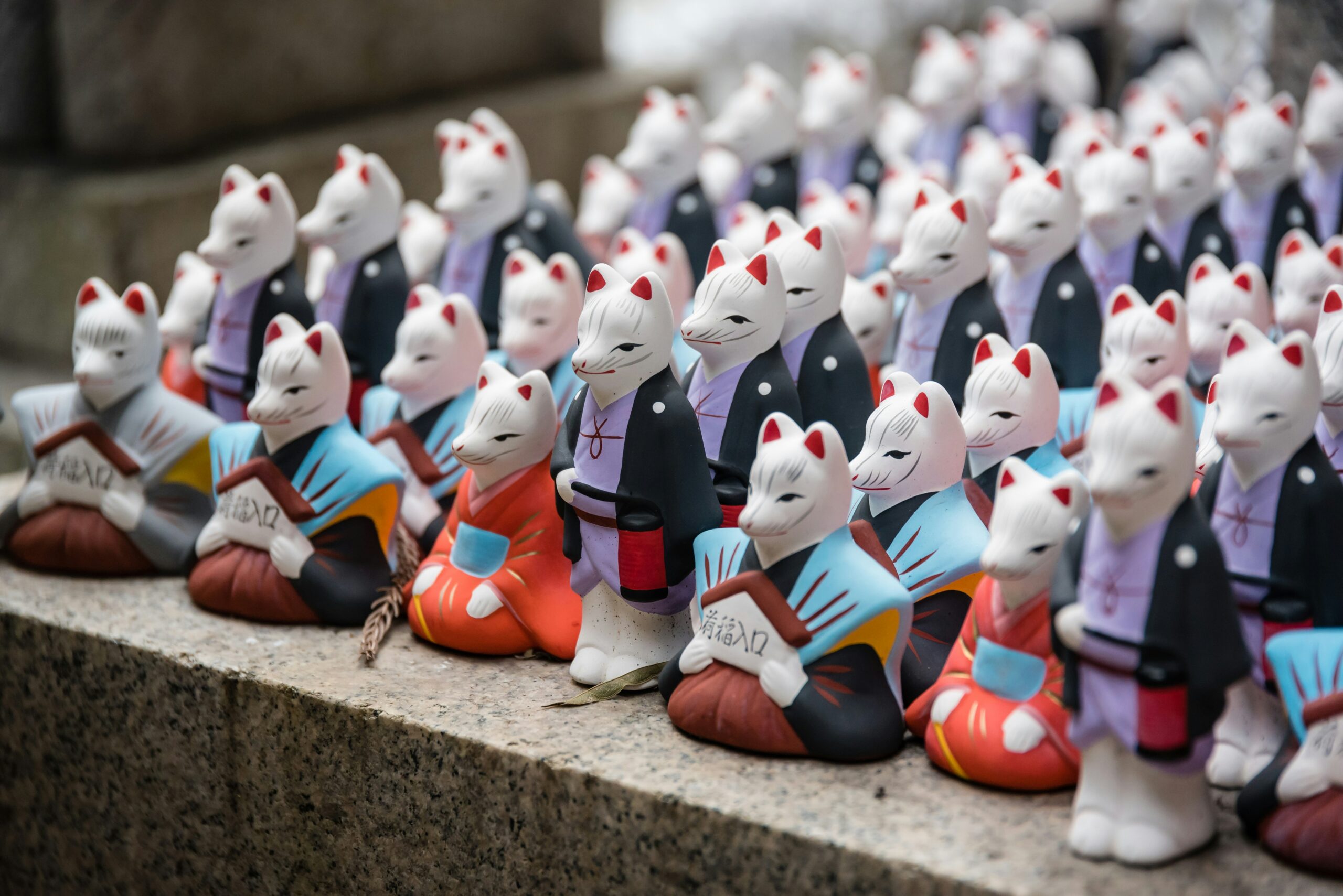 Traditional Japanese fox dolls (kitsune) displayed at a shrine, reflecting the importance of cultural nuance in Japanese localization